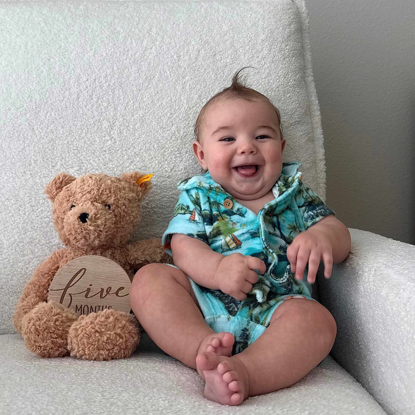 Coast is registered to the contest to win money with this photo: baby, bright, casual_clothing, chair, child, colorful, cozy, cute, happy, indoors, infant, plush_toy, portrait, short_hair, sitting, smiling, soft_fabric, teddy_bear, texture, wooden_sign