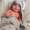 Coast is registered to the contest to win money with this photo: baby, smile, towel, hood, animal_ears, striped_blanket, infant, cute, happy, child, skin, blanket, lying_down, indoors, portrait, soft_texture, wrapped, young, person, cozy