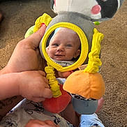 Kaiden Kopas is registered to the contest to win money with this photo: baby, reflection, mirror, toy, panda, hand, carpet, smile, child, cute, play, infant, soft_toy, yellow, orange, blue, clothing, person, closeup, happy