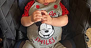 Kaiden Kopas joined the competition — help win amazing prizes! baby, child, car_seat, romper, mickey_mouse, red_buttons, hands, legs, socks, face, eyes, seat_belt, warning_label, black_seat, quilted, indoor, cute, infant, clothing, portrait