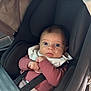 baby, car_seat, child, infant, seatbelt, clothing, hands, face, eyes, car_interior, safety, portrait, cute, young_child, seat, restraint, person, indoors, sitting, looking
