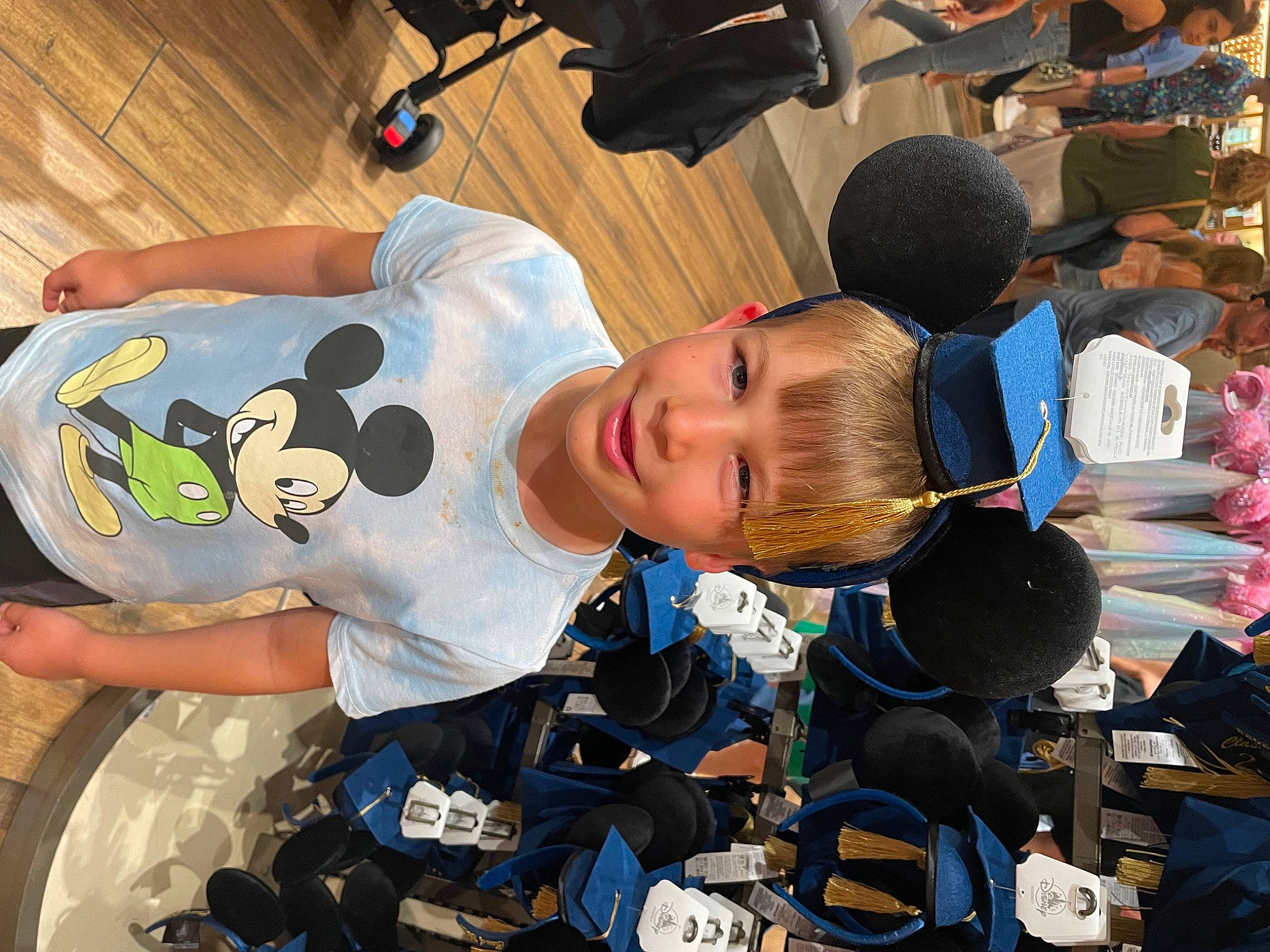Aiden is registered to the contest to win money with this photo: black_hair, child, competition_event, event, fun, headwear, joy, leisure, person, recreation, room, sitting, sleeve, t_shirt, team, toddler, world