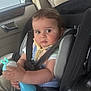 baby, child, car_seat, toy, car_interior, seatbelt, infant, person, holding, clothing, striped_pants, colorful_shirt, safety, seat, cute, closeup, indoor, baby_toy, young_child, car_window