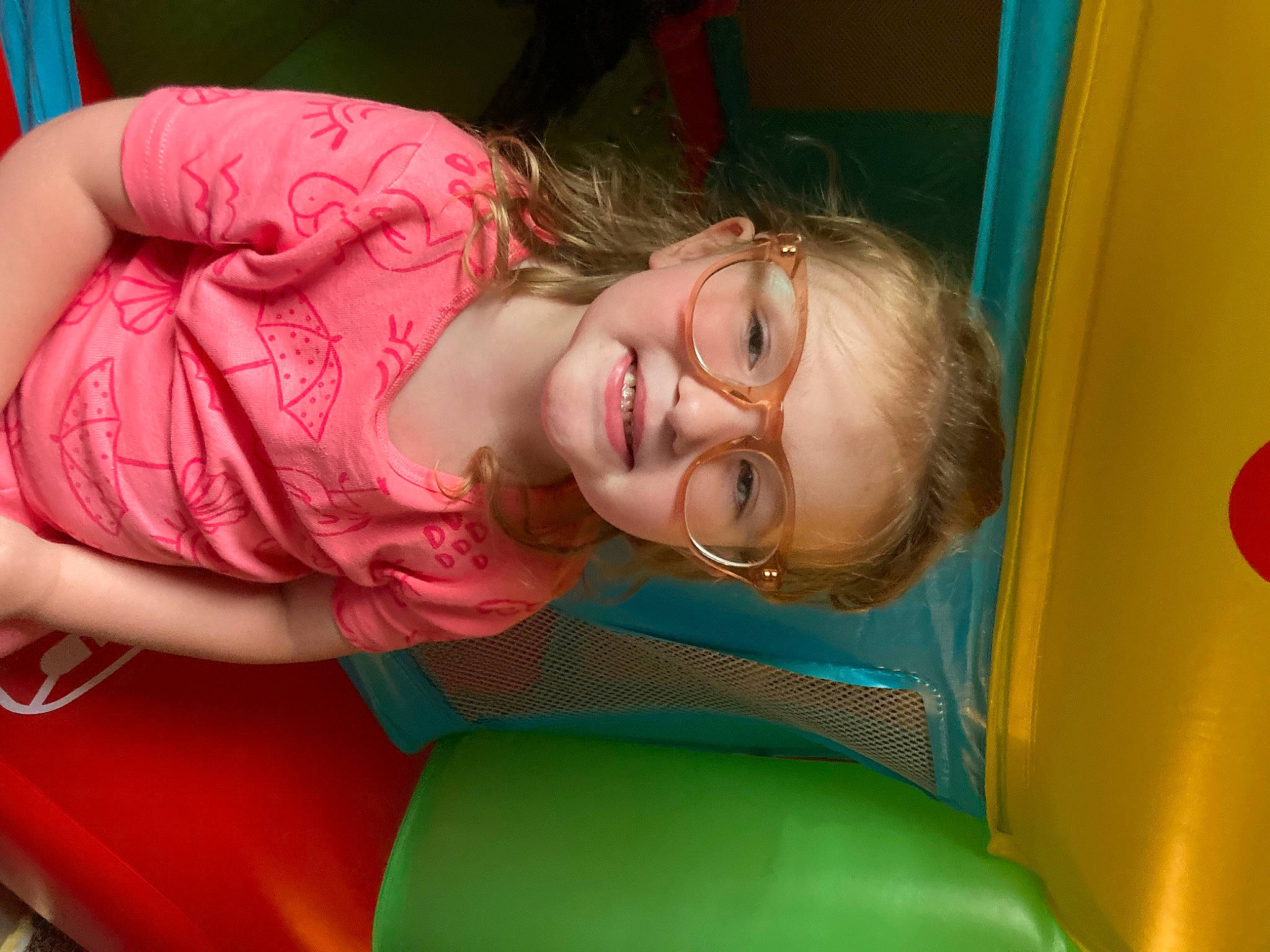 Indie is registered to the contest to win money with this photo: bounce_house, chest, child, comfort, eye, fun, grass, happy, leisure, magenta, mouth, outdoor_play_equipment, person, play, playground, recreation, room, sitting, smile, thigh