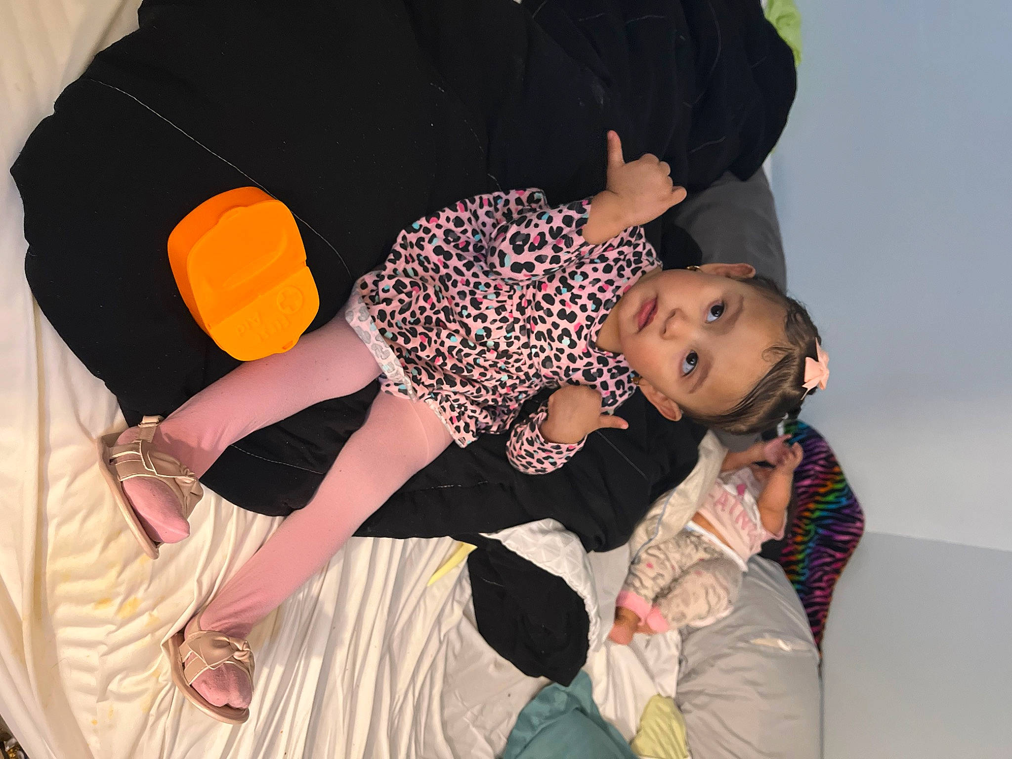 Noemi is registered to the contest to win money with this photo: black_hair, comfort, event, facial_expression, flash_photography, flooring, foot, fun, gesture, happy, human_body, human_leg, knee, leg, leisure, person, plant, thigh, toddler, tree