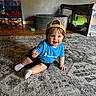 baby, child, cap, blue_shirt, champion, smiling, indoor, rug, toy_shelf, playpen, wooden_floor, socks, crawling, furniture, colorful_toys, happy, person, young_child, cute, home
