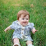 baby, child, grass, field, outdoor, smiling, happy, cute, nature, green, sitting, striped_clothing, white_shoes, young, portrait, playful, summer, daylight, person, casual