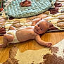 Blake is registered to the contest to win money with this photo: baby, diaper, floor, wooden_floor, rug, play_mat, toy, infant, child, lying_down, smiling, indoor, cute, patterned_rug, quilted_mat, curious, person, skin, head, arm
