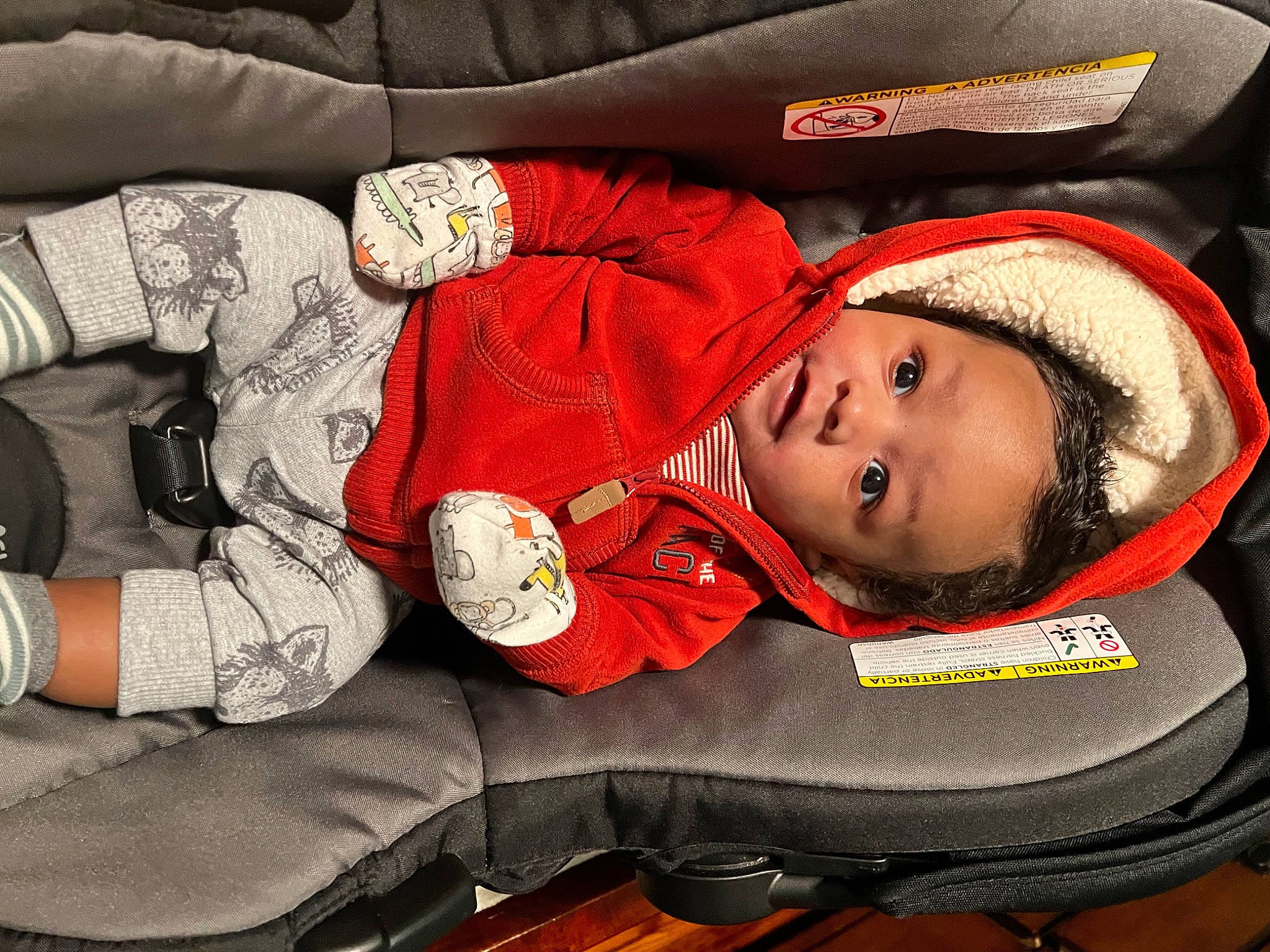 Kyrie is registered to the contest to win money with this photo: baby, baby_carriage, baby_products, baby_safety, baby_sleeping, baby_toddler_clothing, car_seat, carmine, child, comfort, facial_expression, fashion_accessory, head, headgear, lap, person, sitting, sleeve, smile, toddler