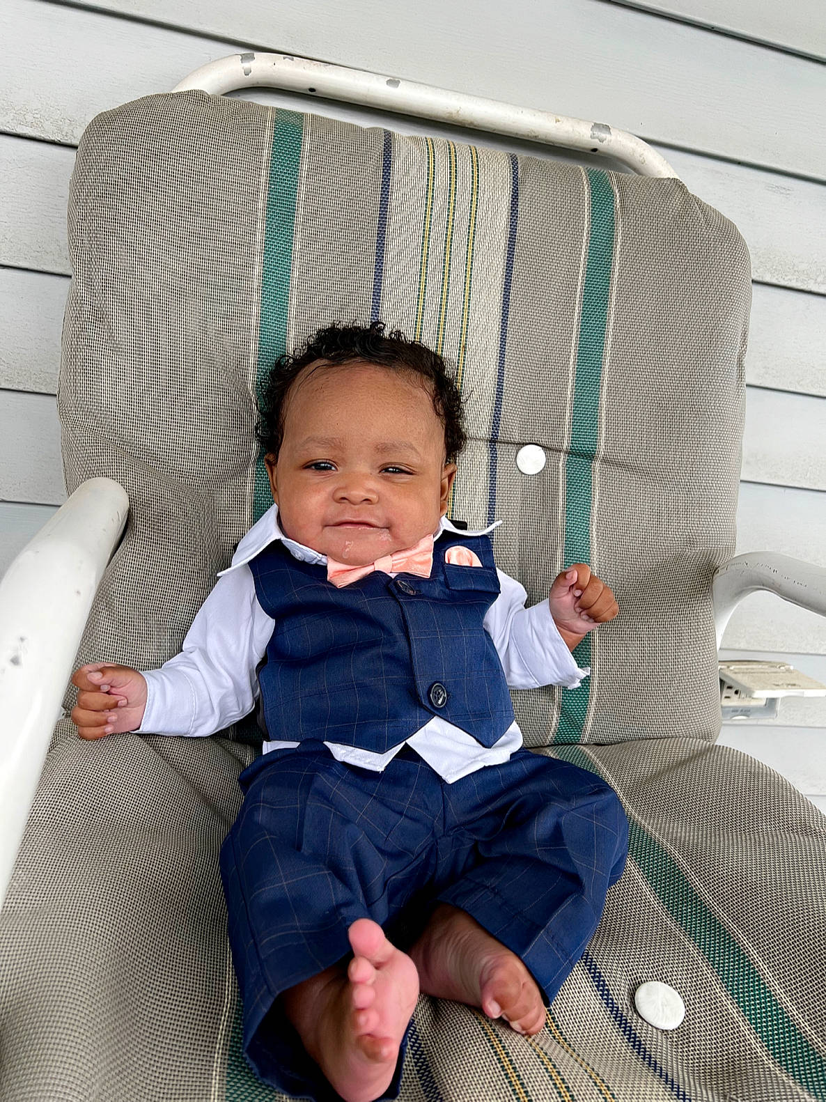 Kyrie is registered to the contest to win money with this photo: baby, baby_products, baby_toddler_clothing, barefoot, chair, child, comfort, foot, fun, hair, infant_bed, lap, leisure, outdoor_furniture, person, room, sitting, skin, sock, toddler