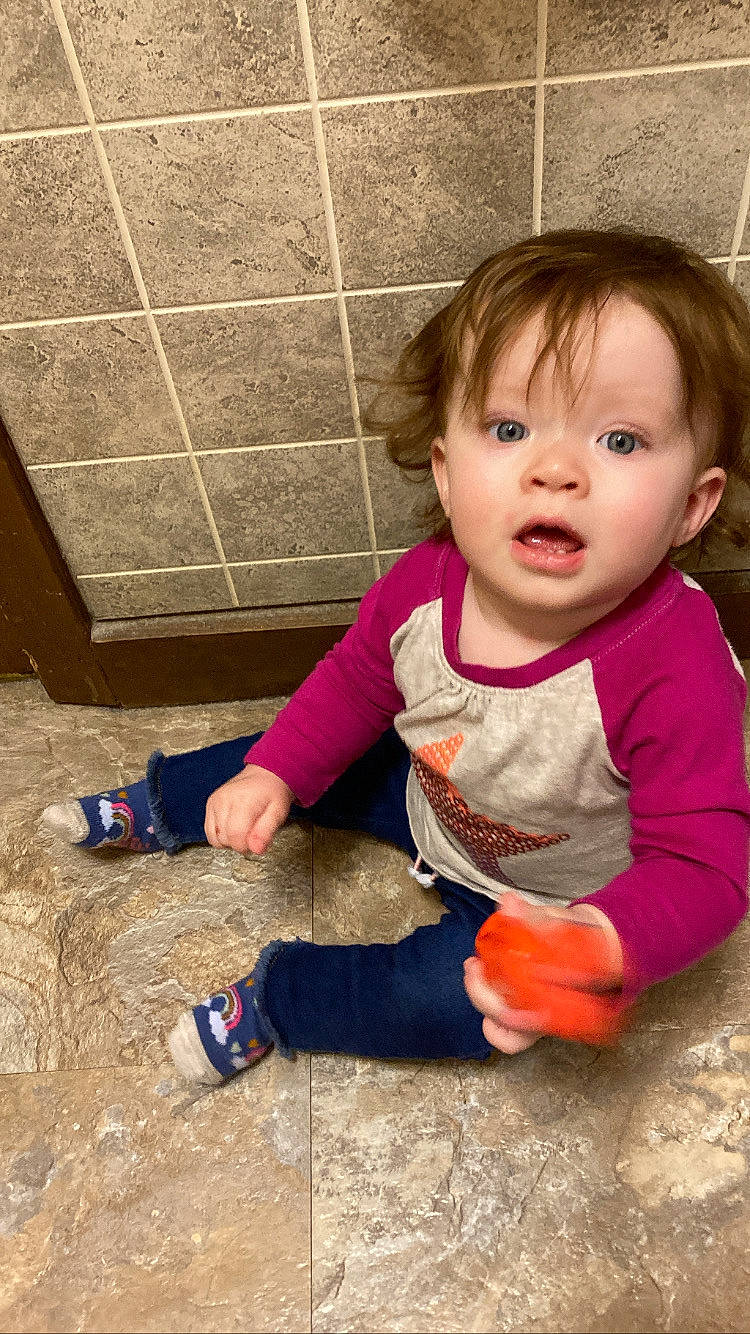 Marie joined the competition — help win amazing prizes! baby, baby_toddler_clothing, cheek, child, floor, flooring, fun, grass, happy, hardwood, human, human_leg, person, play, sitting, skin, sleeve, smile, soil, surprise