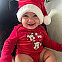 baby, smiling, red_clothing, santa_hat, mickey_mouse, minnie_mouse, indoor, couch, plant, cute, infant, holiday, christmas, portrait, child, happy, sitting, festive, cozy, person