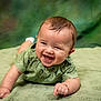 baby, smiling, green_shirt, lying_down, blanket, happy, cute, infant, portrait, face, child, toddler, skin, hair, indoors, crawling, expression, small_hands, closeup, eyes