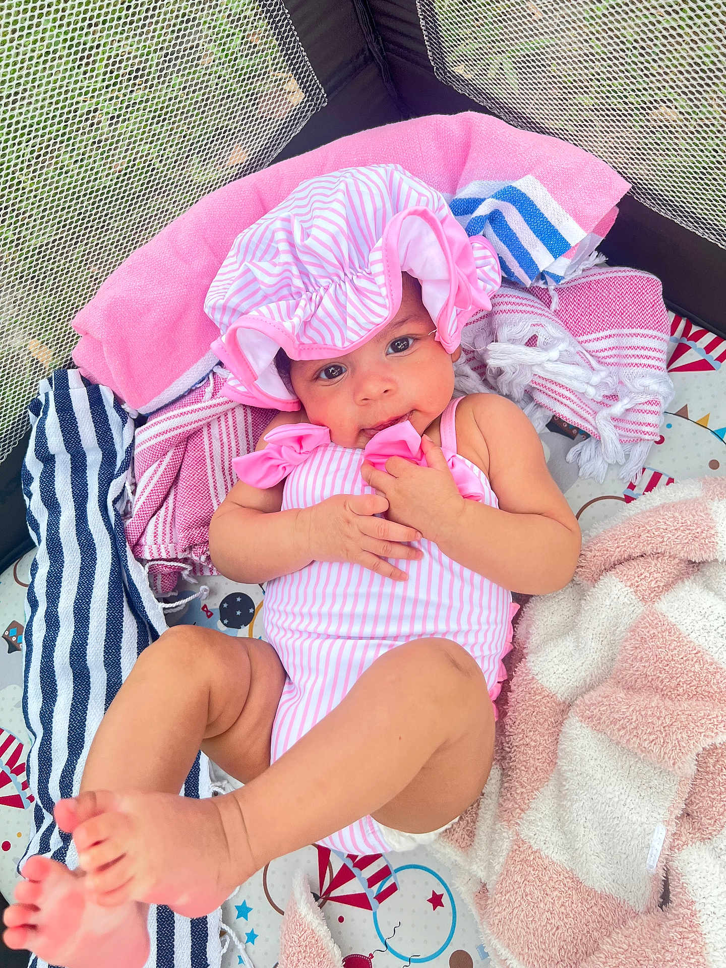 Talayah joined the competition — help win amazing prizes! baby, infant, child, swimsuit, bonnet, blanket, towel, playmat, indoors, cute, skin, foot, hand, face, smile, striped, pink, relaxing, lying, soft