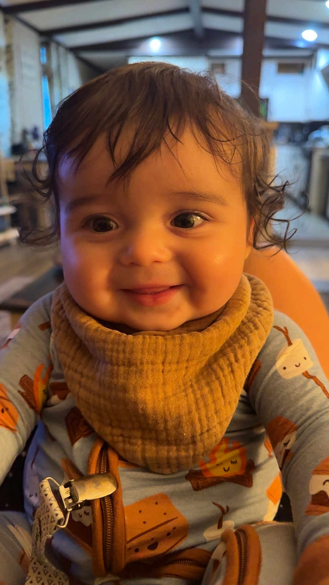 Stetson joined the competition — help win amazing prizes! baby, child, smile, indoor, cozy, bib, clothing, curly_hair, face, happy, person, portrait, infant, cute, warm_lighting, home, expression, young, sitting, closeup