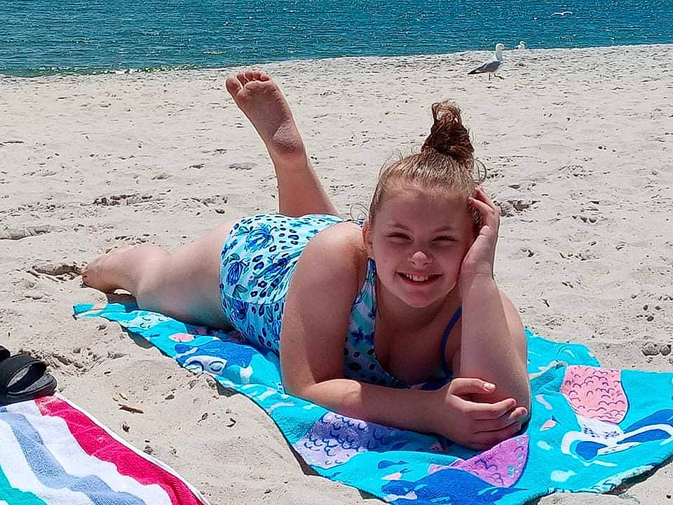 Audrianna is registered to the contest to win money with this photo: barefoot, beach, blue, body_of_water, cool, fun, hairstyle, happy, human, human_body, joy, leisure, morning, natural_environment, people_in_nature, people_on_beach, person, smile, sunlight, swimwear