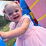 Eliza a rejoint le concours — aidez-le/la à gagner de superbes lots ! toddler, child, smiling, pink_dress, outdoor, inflatable, play, happy, face, hair_accessory, grass, daylight, fun, cute, joy, person, young_child, blue, pink, closeup