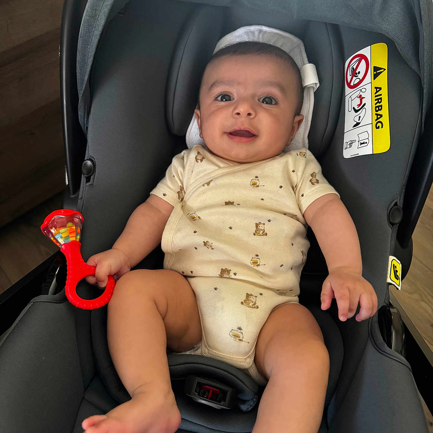 Noah participe au concours pour gagner de l'argent avec cette photo : baby, infant, car_seat, rattle, smiling, child, happy, indoors, clothing, seat, toy, person, cute, small, safety, baby_clothes, car_accessory, young_child, head, legs