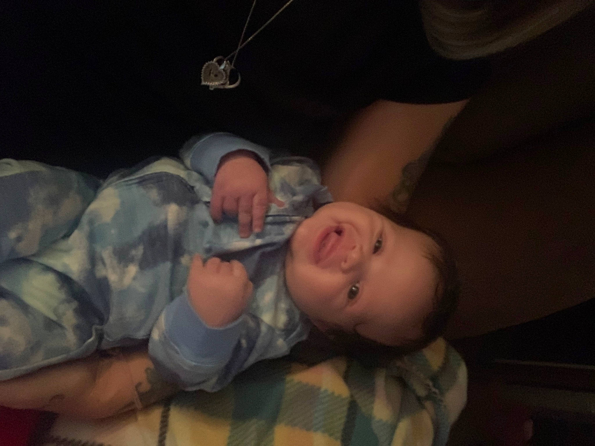 Kolby is registered to the contest to win money with this photo: baby, baby_products, baby_toddler_clothing, cheek, child, comfort, darkness, ear, elbow, fun, military_camouflage, mouth, night, nose, pattern, person, room, smile, space, toddler