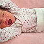 baby, newborn, infant, sleepwear, pajamas, polka_dot, pink, white, blanket, stretching, yawning, lying_down, cozy, cute, soft, child, person, indoors, resting, portrait