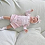 Mya participe au concours pour gagner de l'argent avec cette photo : baby, infant, child, couch, pillow, headband, bow, pink_clothing, striped_shirt, shorts, socks, soft_texture, cozy, indoor, portrait, cute, lying_down, small_child, comfortable, home