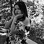 child, girl, black_and_white, portrait, outdoor, trees, nature, flower_pattern, dress, bow, pouting, posing, railing, young, person, smile, leisure, fashion, casual, daylight