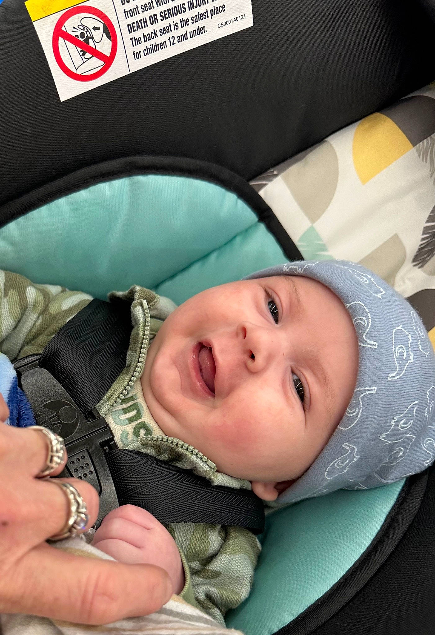 Jayden is registered to the contest to win money with this photo: auto_part, baby, baby_carriage, baby_in_car_seat, baby_products, baby_safety, baby_toddler_clothing, car_seat, cheek, child, comfort, fashion_accessory, headwear, linens, nail, person, sitting, sleep, smile, thumb