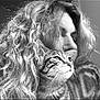 black_and_white, cat, tabby_cat, woman, curly_hair, portrait, close_up, affection, pet, animal, indoor, calm, serene, face, whiskers, feline, human, snuggle, love, soft_light