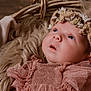 baby, infant, face, headband, flower_crown, pink_dress, lace, fur, basket, portrait, newborn, cute, soft_texture, cozy, child, looking_up, closeup, skin, head, adorable