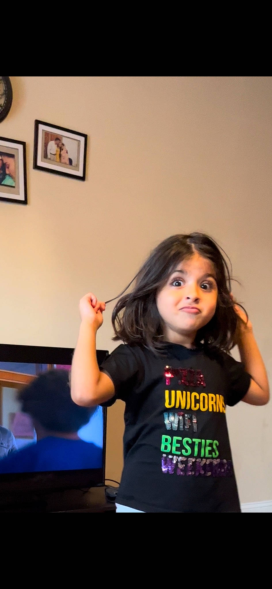 Zarish is registered to the contest to win money with this photo: chair, child, electric_blue, event, fashion_design, fun, gesture, happy, joint, long_hair, person, picture_frame, room, shoulder, sitting, sleeve, t_shirt, toddler, waist