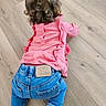 baby, back_view, blue_jeans, casual_clothing, child, crawling, curly_hair, cute, denim, flooring, home, indoor, infant, mickey_mouse_label, pink_top, ruffles, socks, toddler, wooden_floor, young_child