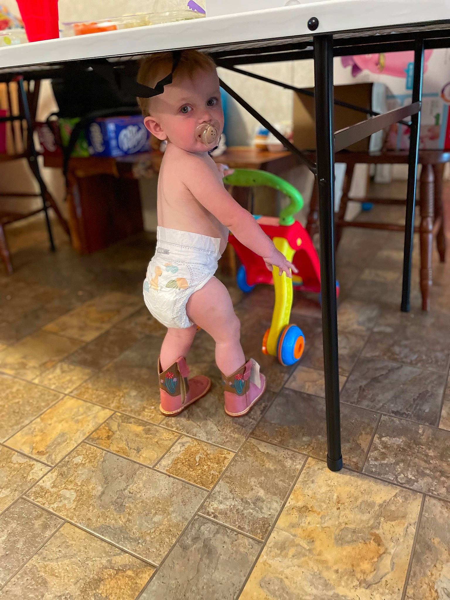 Alaina joined the competition — help win amazing prizes! baby, chair, child, floor, flooring, foot, fun, happy, human_leg, knee, leg, leisure, outdoor_furniture, person, sandal, shorts, sock, table, thigh, toddler
