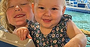 Susie joined the competition — help win amazing prizes! baby, blonde_hair, candid, children, family, floral_dress, girl, happy, indoor, playground, playpen, poolside, portrait, recreation, sister, smiling, swimming_pool, toddler, water, wooden_ceiling