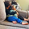 Osman joined the competition — help win amazing prizes! children, child, toddler, siblings, hugging, couch, indoors,  cozy, family, sleeping, sitting, tablet, mug, blanket, cushion, brown_hair, blue_pants, green_shirt, living_room, portrait