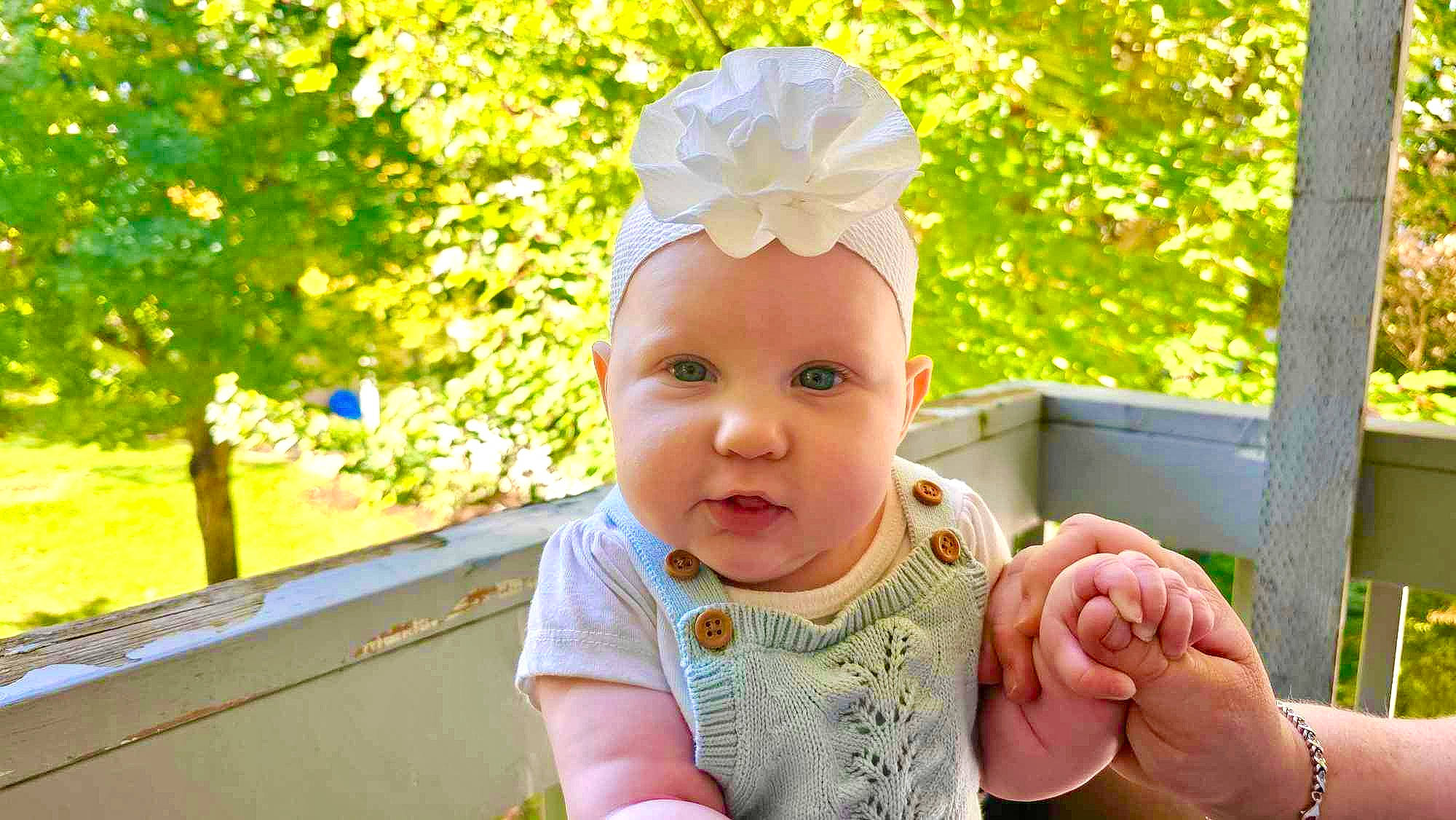 Aniah is registered to the contest to win money with this photo: baby, baby_toddler_clothing, cap, child, finger, fun, gesture, grass, hand, happy, leaf, leisure, people_in_nature, person, photograph, pink, plant, smile, summer, thumb