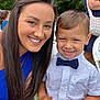 Adrian is registered to the contest to win money with this photo: woman, child, smile, bow_tie, outdoor, greenery, short_hair, long_hair, happy, casual_clothing, portrait, people, nature, event, chair, daylight, family, gathering, face, closeup