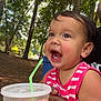 child, cup, daylight, drink, excited, forest, greenery, hand, happy, nature, outdoor, person, pink_clothing, playful, smiling, straw, striped_clothing, summer, toddler, trees