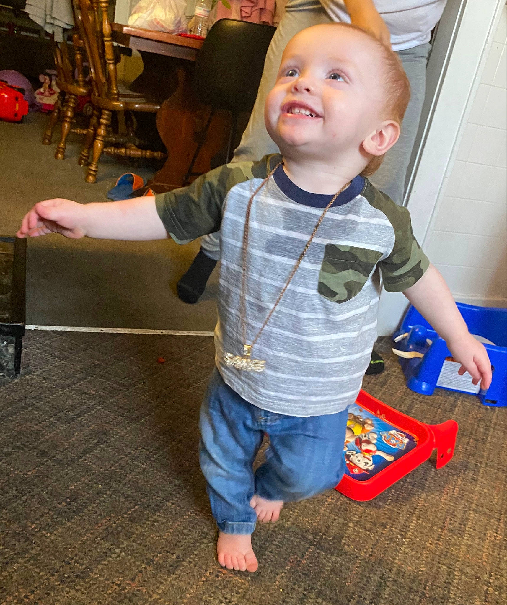 Brandon is registered to the contest to win money with this photo: baby, baby_toddler_clothing, cheek, child, eye, flooring, fun, happy, pattern, person, play, room, sitting, skin, sleeve, smile, standing, t_shirt, toddler, toy