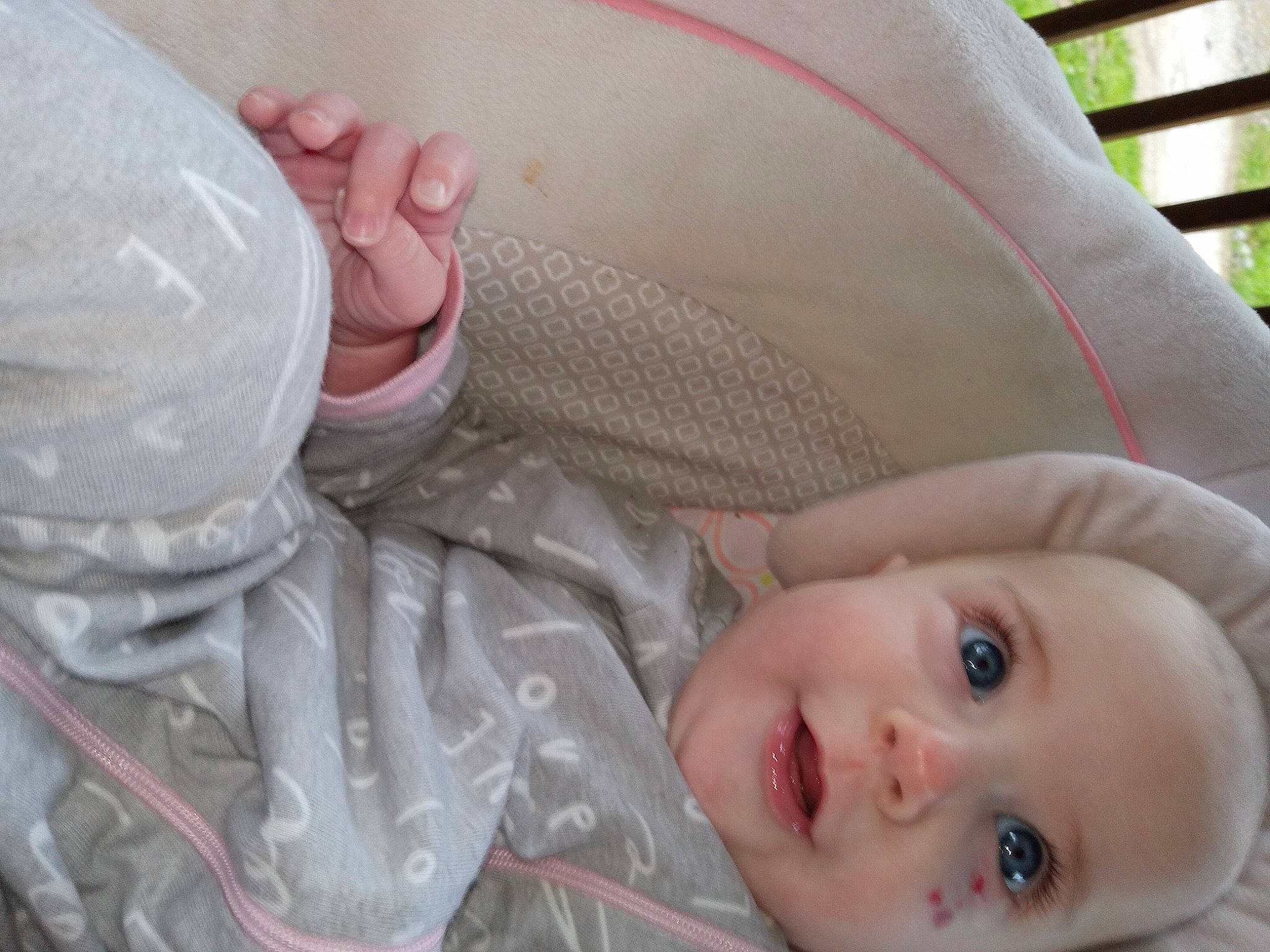 Ophelia joined the competition — help win amazing prizes! baby, baby_toddler_clothing, cheek, child, close_up, comfort, fashion_accessory, grass, headgear, helmet, human, lip, mouth, nose, person, personal_protective_equipment, product, sitting, skin, smile