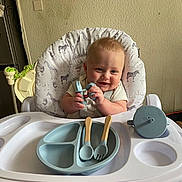 Kayson joined the competition — help win amazing prizes! baby, high_chair, baby_utensils, fork, spoon, sippy_cup, feeding, smile, child, infant, cute, happy, kitchen, plate, seat, animal_print, giraffe, zebra, wall, indoor