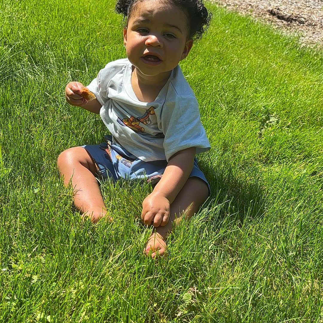 Deion joined the competition — help win amazing prizes! backyard, clothing, face, field, grass, grassland, green, head, lawn, nature, outdoors, park, person, photography, plant, portrait, shorts, summer, vegetation, yard