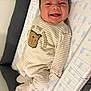Matthew is registered to the contest to win money with this photo: baby, infant, smiling, onesie, striped_clothing, face, lying_down, happy, cute, child, pattern, changing_pad, soft_fabric, indoors, portrait, newborn, person, apparel, baby_garment, sleepwear