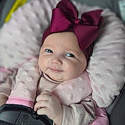 Shaylee joined the competition — help win amazing prizes! baby, infant, child, car_seat, safety_harness, pink_bow, headwear, soft_cushion, smile, cute, portrait, indoors, clothing, hand, face, eyes, baby_girl, comfort, seatbelt, closeup