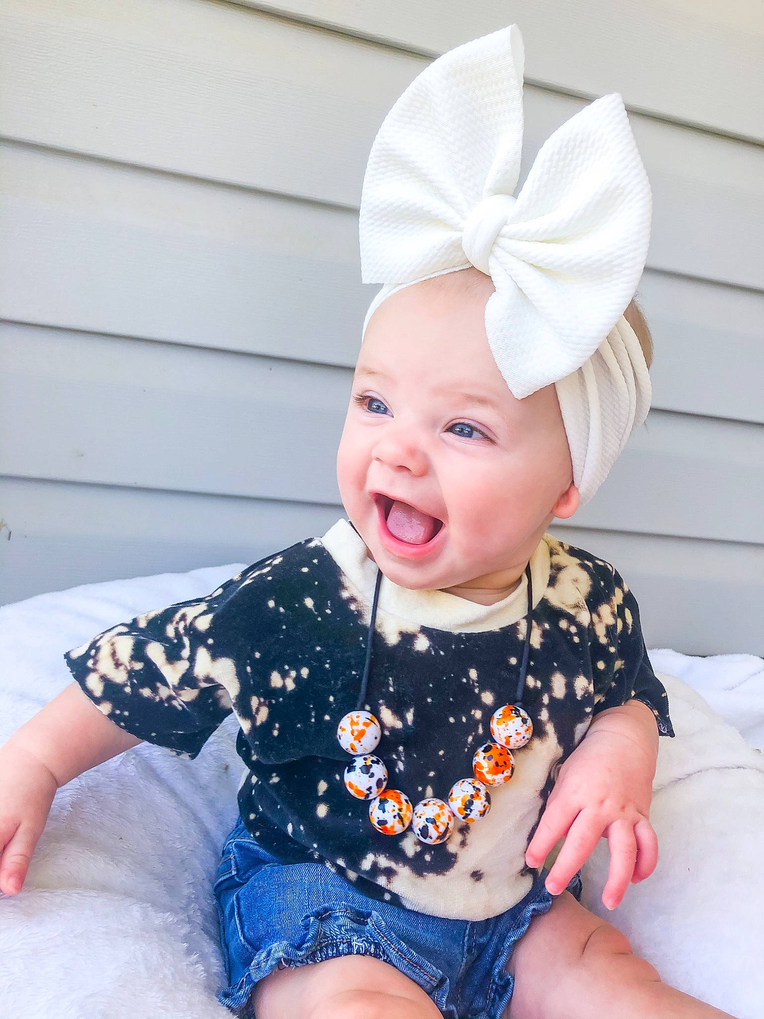 Kristen joined the competition — help win amazing prizes! baby, baby_toddler_clothing, child, clothing, costume_hat, fashion_accessory, fun, happy, hat, headgear, headwear, human_body, human_leg, party_supply, pattern, person, pink, sitting, sleeve, smile