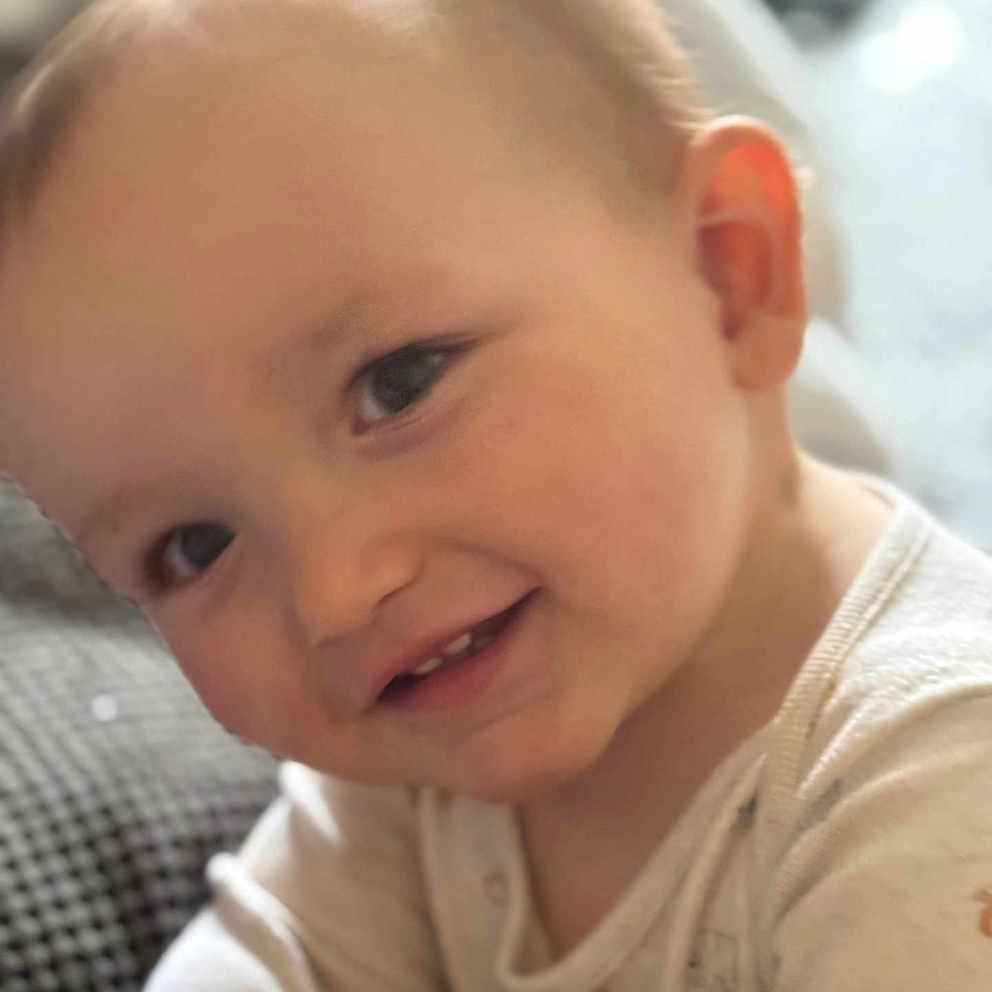 Elis joined the competition — help win amazing prizes! baby, cheeks, child, closeup, cute, ear, expression, eyes, face, happy, head, indoors, infant, onesie, person, portrait, skin, smiling, soft_light, young