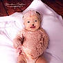 baby, infant, child, pink_lace, headband, smile, blanket, soft_texture, portrait, cute, laying_down, indoors, wooden_floor, delicate, happy, young_child, one_person, infant_clothing, newborn, toddler