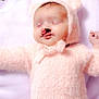 baby, infant, sleeping, pink_clothing, fuzzy_outfit, hood, cleft_lip, cleft_palate, newborn, pale_skin, soft_texture, blanket, cute, peaceful, lying_down, hand, closed_eyes, indoors, portrait, child