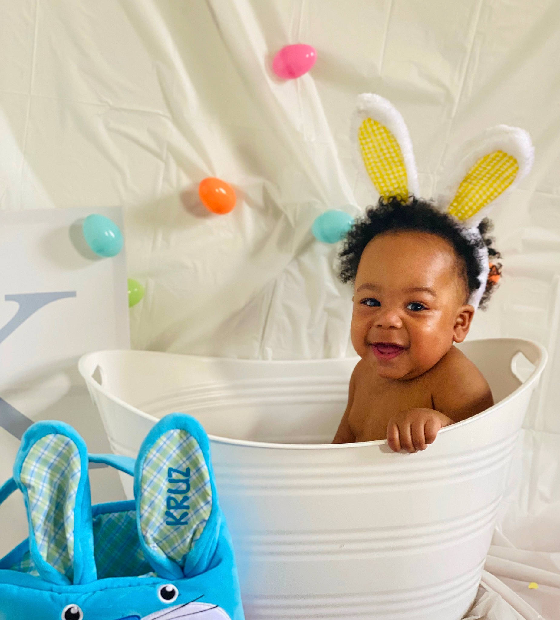 Kruz is registered to the contest to win money with this photo: baby_products, baby_toddler_clothing, bathing, blue, child, comfort, electric_blue, event, fashion_accessory, fun, happy, headband, headpiece, leisure, party_supply, pattern, person, product, smile, toddler