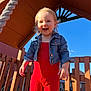 Scarlett is registered to the contest to win money with this photo: blue_sky, casual_clothing, child, cute, daylight, denim_jacket, fun, happy, nature, outdoor, person, play, playground, red_outfit, smiling, summer, sunlight, toddler, wooden_structure, young_child