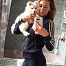 Múshu a rejoint le concours — aidez-le/la à gagner de superbes lots ! woman, dog, mirror, selfie, bathroom, tiled_wall, curtain, smartphone, pet, casual_clothing, black_jacket, long_hair, white_dog, reflection, indoor, portrait, holding, looking_at_camera, light, relaxed
